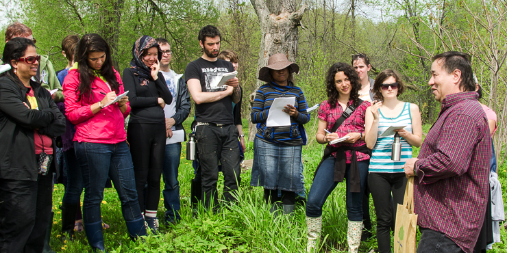 McGill students listen as they go on a medicine walk as part of the Aboriginal Field Course.