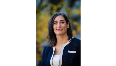 Professor Lara Khoury, a white woman with shoulder length black and grey hair. She is wearing a navy blazer with white highlights