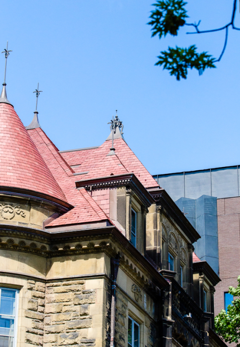 The red slate peaked roof of Old Chancellor Day Hall on a sunny day. Photo by Lysanne Larose.