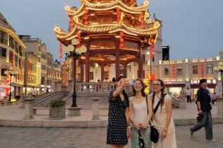 Students posing in front of a pavilion