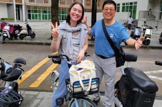 Student and professors standing near bicycles