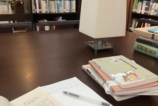 Books laid out on a table in a library