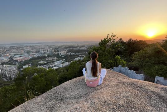 Albertine sitting and watching the sunset over Shantou