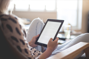 woman reading on an ipad