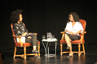 Photo of Amanda Parris (left) and Esi Edugyan (right) seated on stage at the lecture.