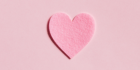 Cutout of pink heart against a pink background