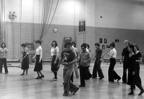 Group of students practicing in gymnasium during an instructional dance class. (photo n.d.). MUA PU024174.