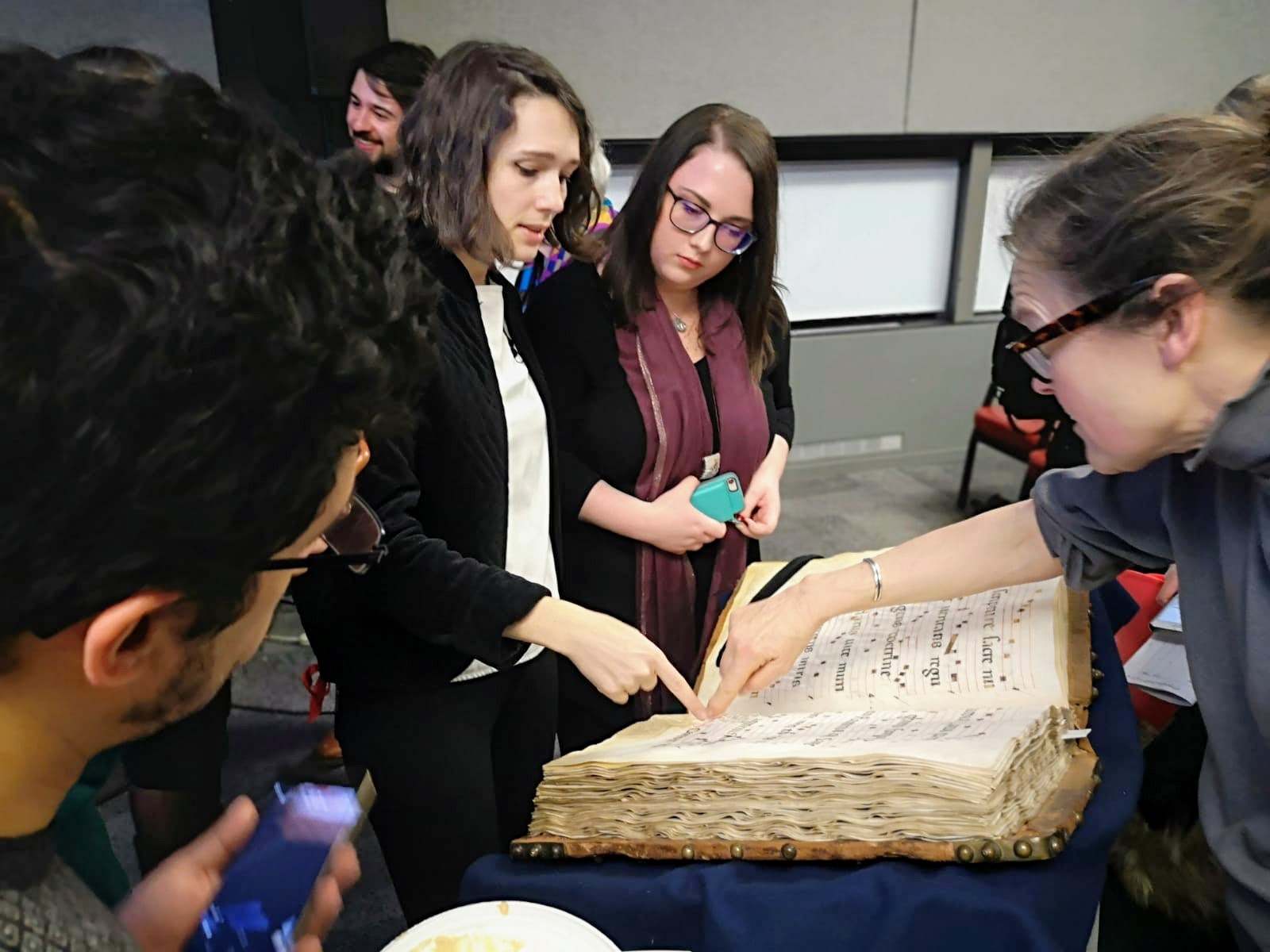 Crowd admiring Manuscript 73 after the chant portion of the event