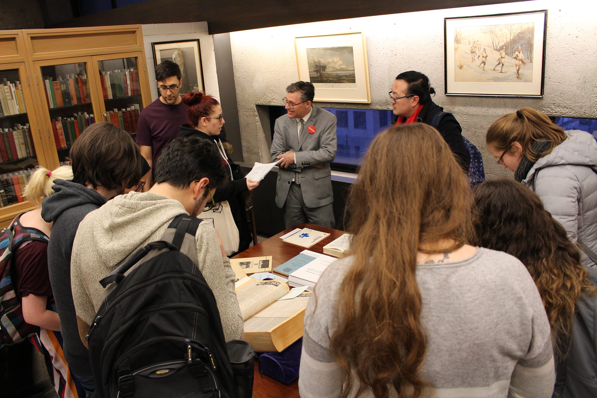 Event attendees examining archival and rare materials on display for the evening.