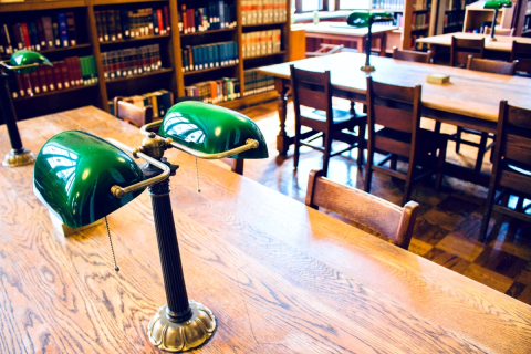 Wooden tables and chairs in the Birks Reading Room.