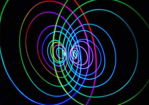Digital image of colourful lines on a black background.