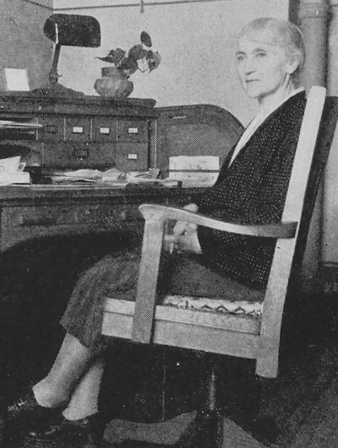 Historical unsung hero Bessie Philip sitting at her desk.