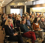 crowd listening in the colgate room