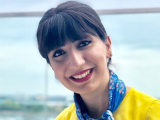 Sahar wearing a yellow shirt by the sea
