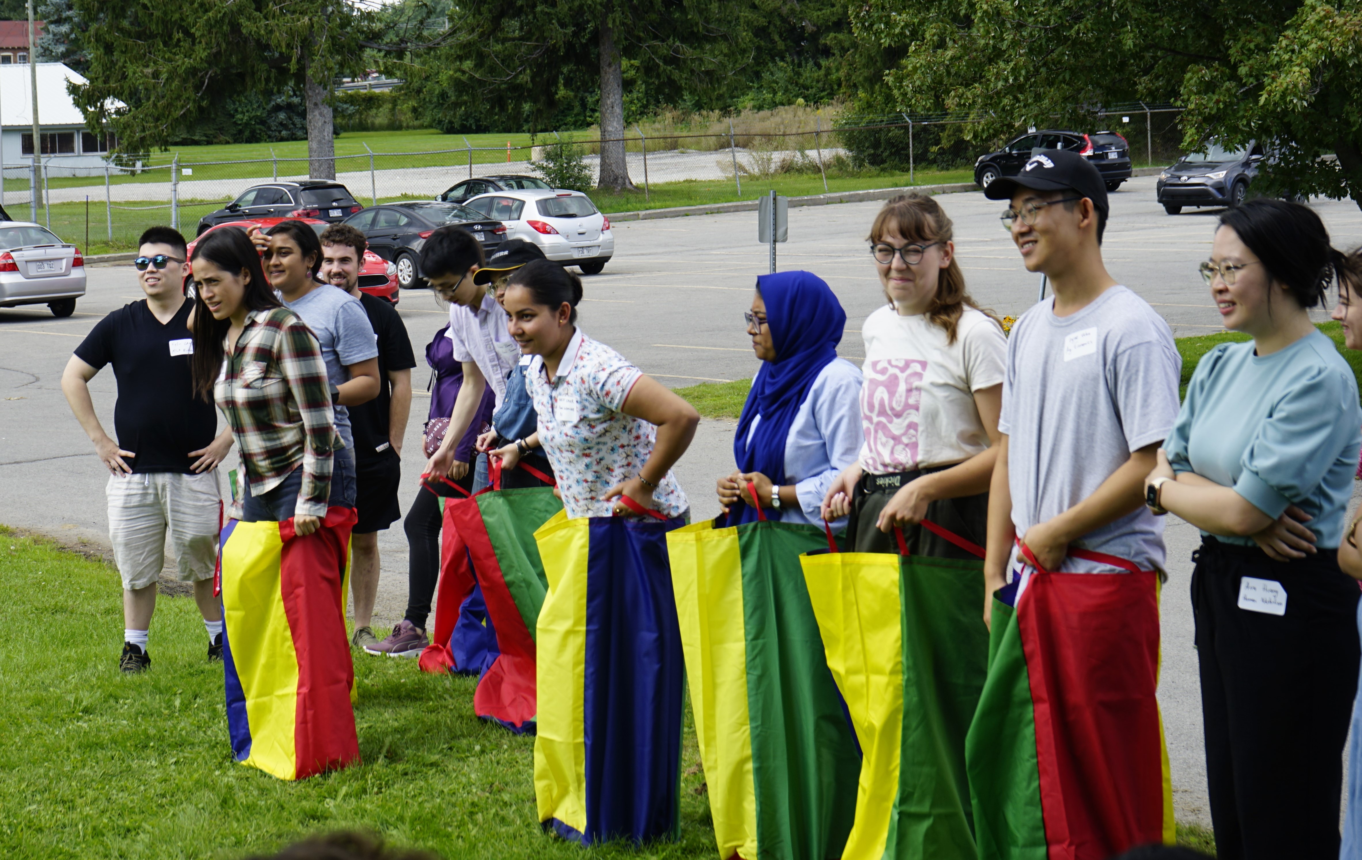 Students stand outside, readying themselves for a potato sack race