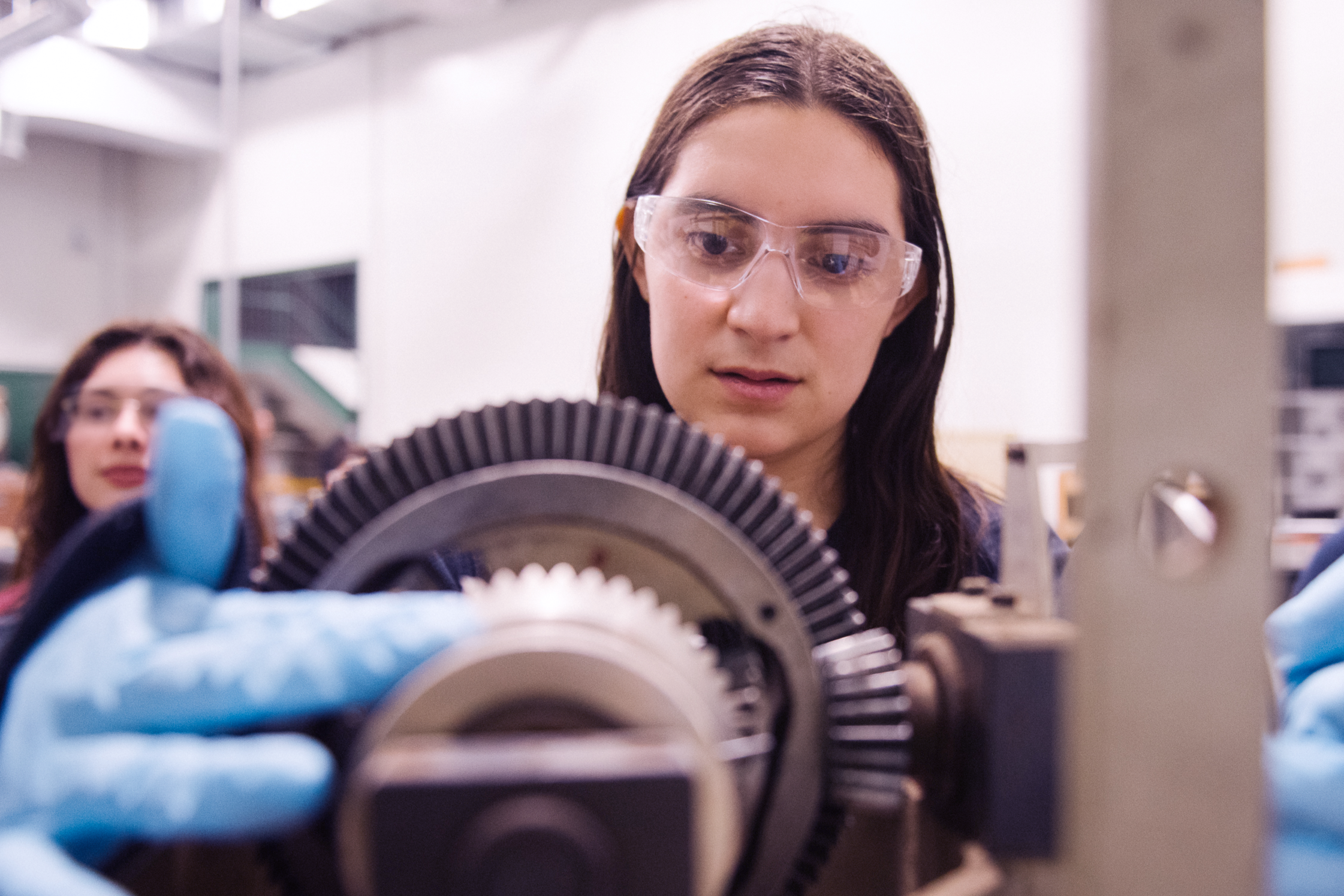 A student in the bioresource engineering shop uses a machine
