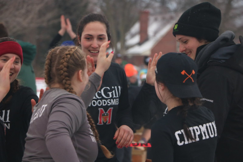 Members of the McGill logger sports team high five each other