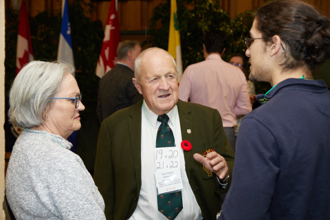 Two alumni talking to a student at the Scholastic Awards reception