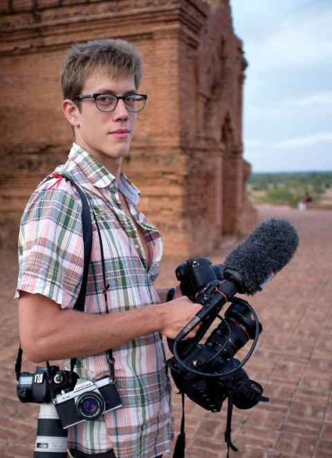 Alex Pritz holding filming equipment