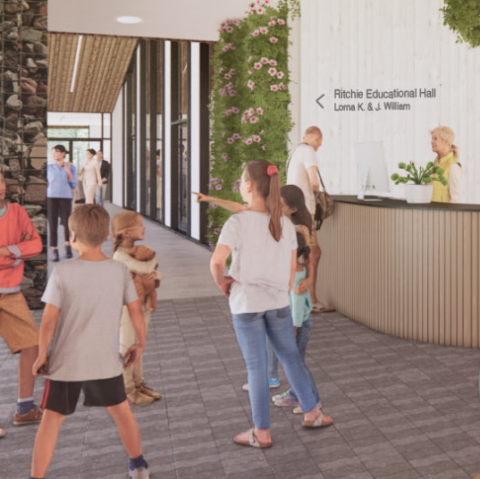 An architectural render of the interior of the planned Community Engagement Centre, with children and community members gathering.
