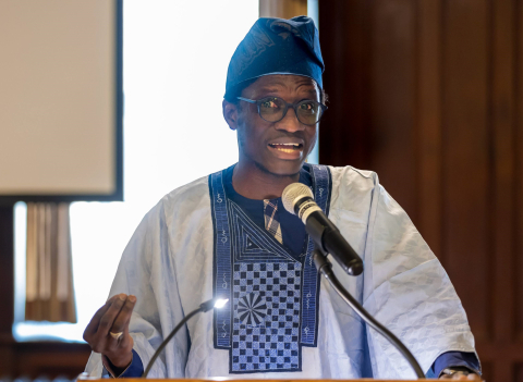 A Mastercard Foundation Scholar speaks at a podium