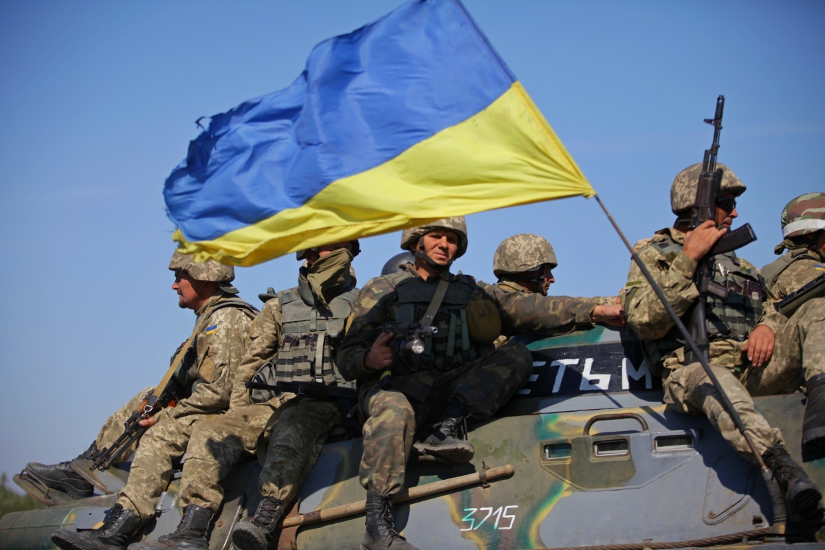 Ukrainian soldiers in 2015 with Ukraine flag on top of tank