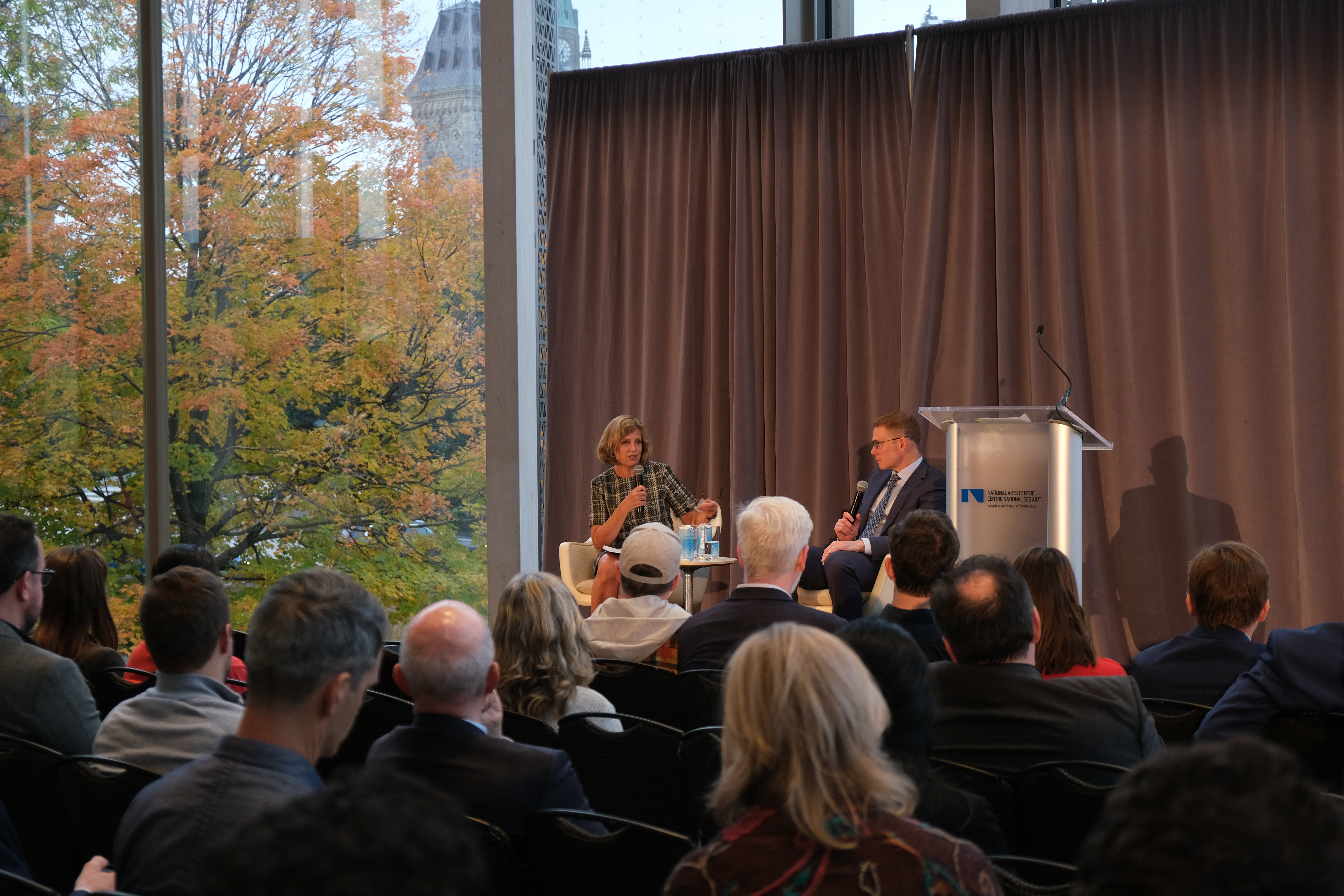 Room of Ottawa lecture attendees listening to Andrew Leach on stage.