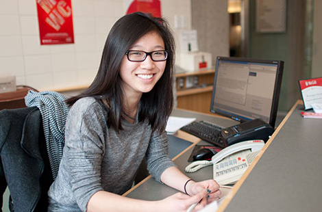 McGill employee sitting behind a reception counter