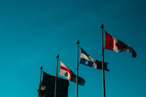 The Montreal, Quebec, and Canadian flags fly above