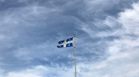 The Quebec flag flies on a flagpole