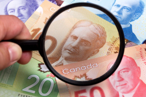 photo with a magnifier over a range of canadian dollars