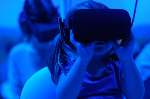 A child gazes through alternative reality (AR) goggles