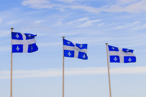 Three Quebec flags on poles