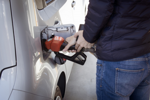 A person fills up the gas tank of their car