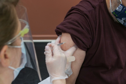 A person administers a vaccine