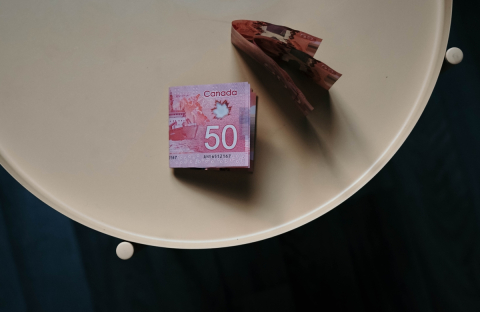 photo of three 50 Canadian dollar bills on a table 