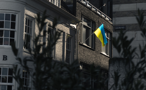 A Ukrainian flag flies over an empty street
