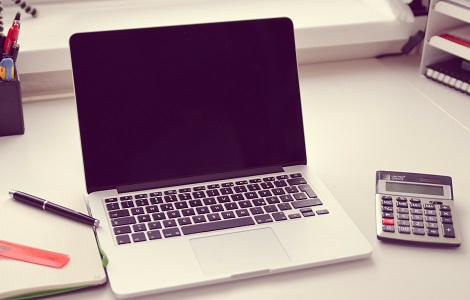 laptop computer and calculator on a table