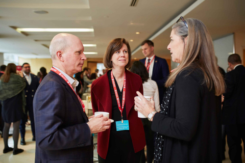 Three people engaged in conversation