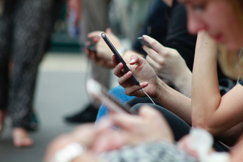 Several people engrossed in content on their cell phones