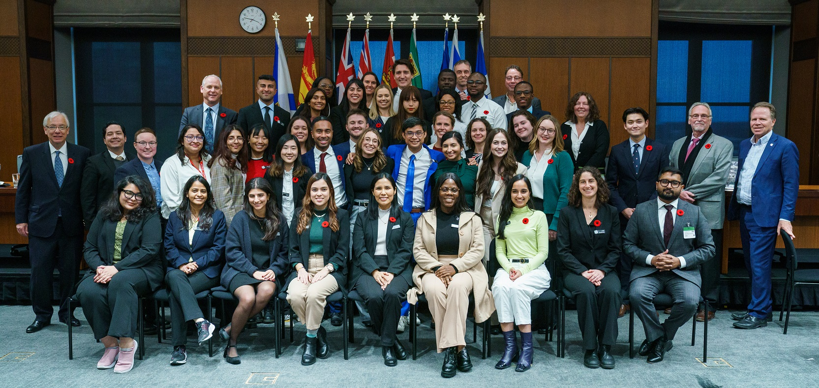 The McGill Master of Public Policy students positioned in a classroom-like setting while taking a group picture with Prime Minister Justin Trudeau.