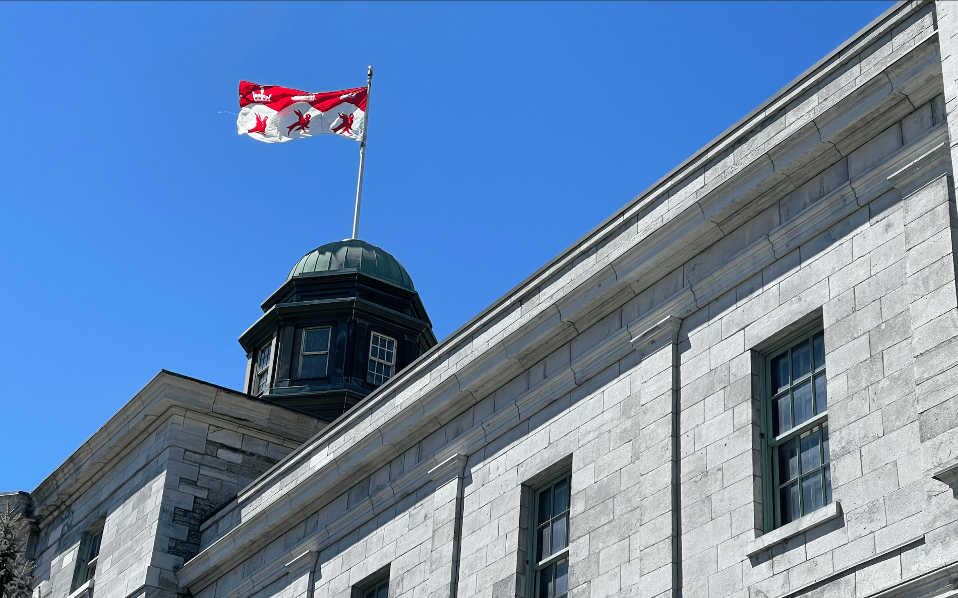 The McGill flag flies above the Arts Building