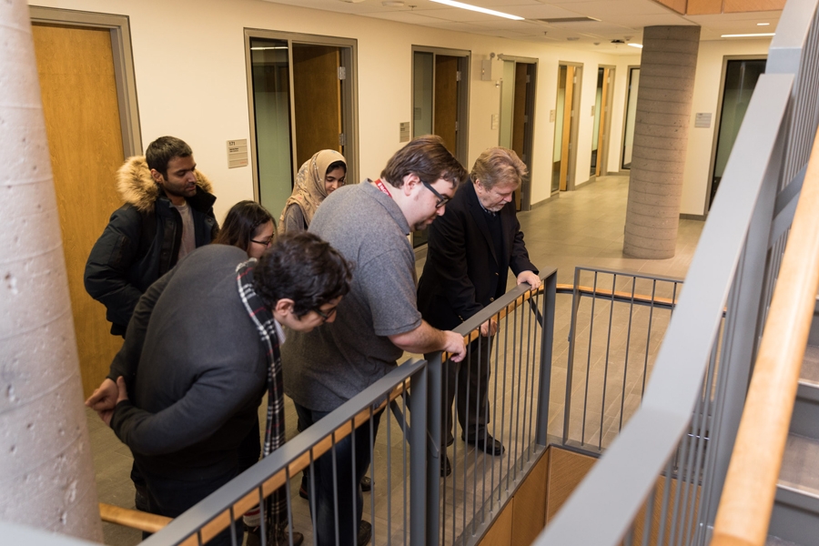 Alfred Jaeger, Academic Director, MBA &amp; PMBA, giving a building tour to a group of MBA students.