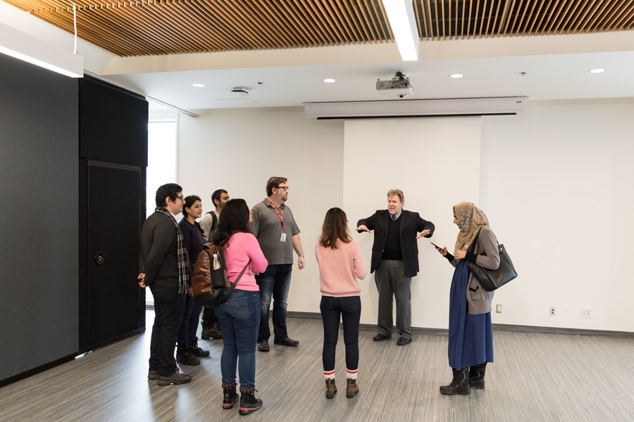 Alfred Jaeger, Academic Director, MBA &amp; PMBA, giving a building tour to a group of MBA students.