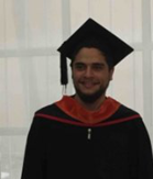 Ibrahim El-Bojairami smiling at camera in convocation gown and hat