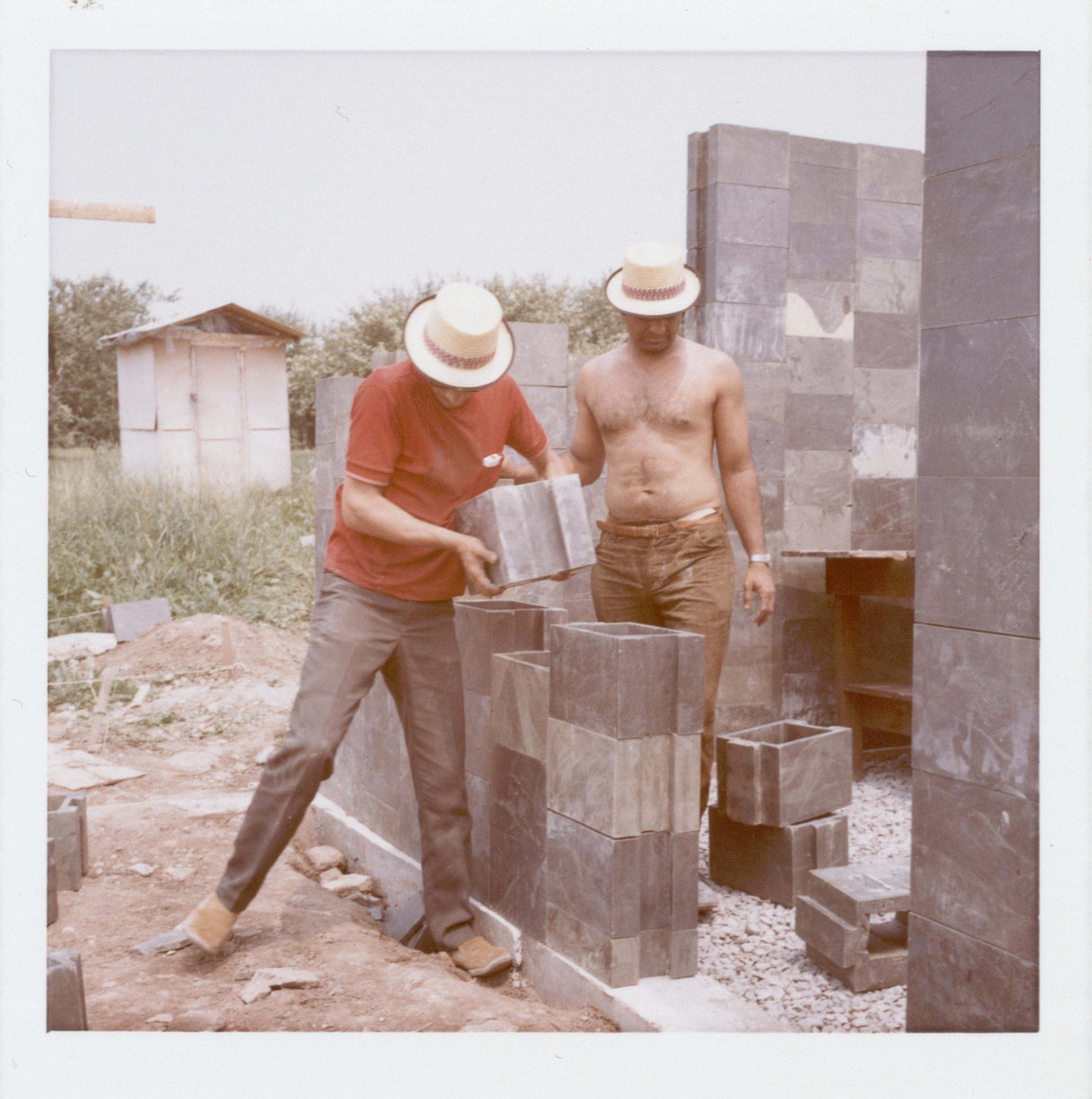 Two men building the ECOL house