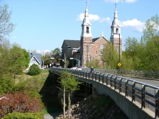 A bridge with a church at the end of it.