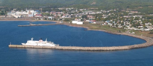 Aerial view of Chandler's harbor. You can see the town and a big boat.