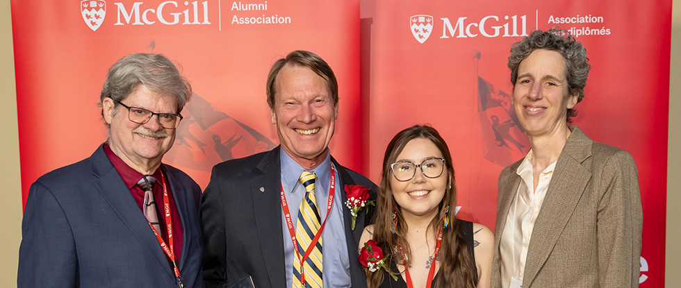 Three award winners and Dean of the FMHS standing in front of red McGill banner.