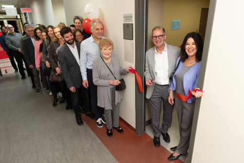 Ribbon-cutting A couple cuts the ribbon on a room